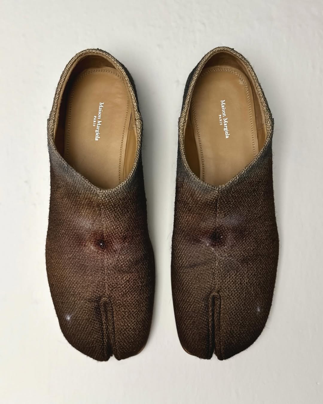 Para butów Tabi z namalowanymi na nich oczami, praca autorstwa malarza Jędrzeja Bieńko